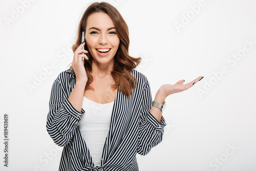 Portrait of a smiling casual girl talking on mobile phone