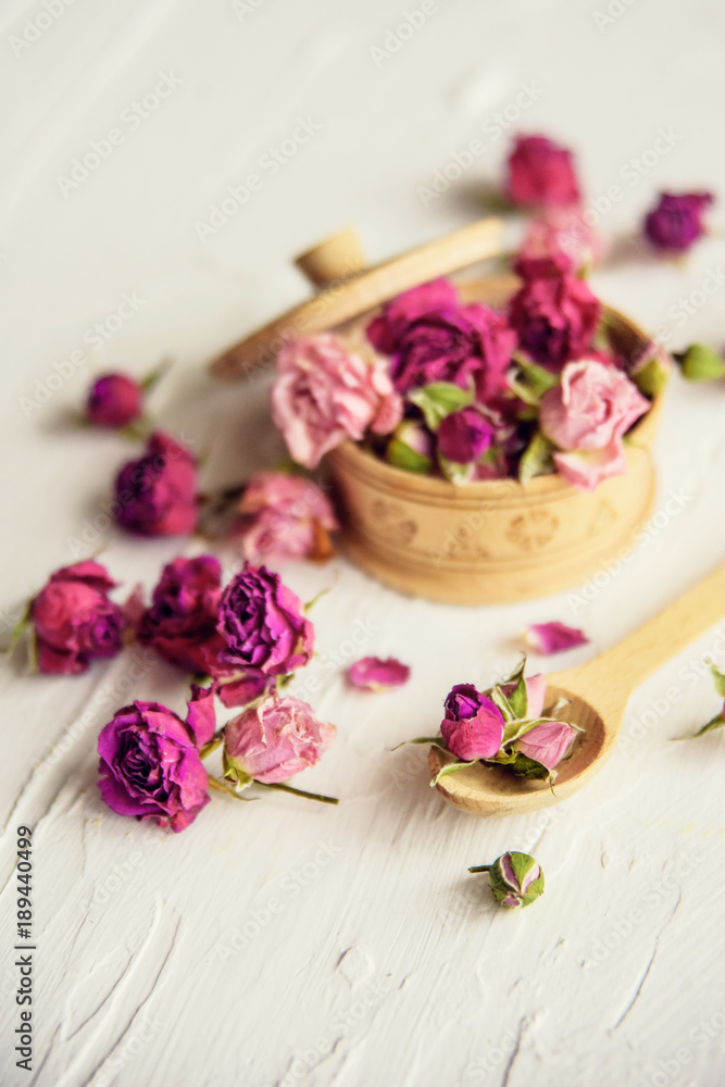 pink buds in a glass jar on a white background