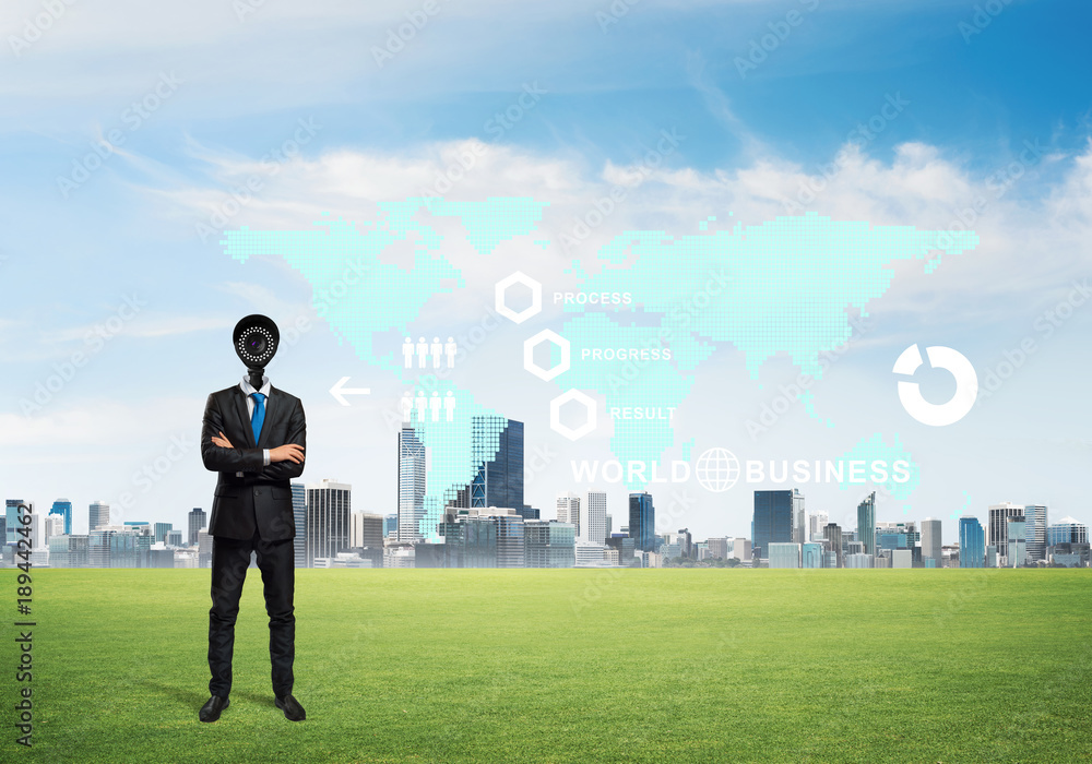 Camera headed man standing on green grass against modern cityscape Camera headed man standing on green grass against modern cityscape
