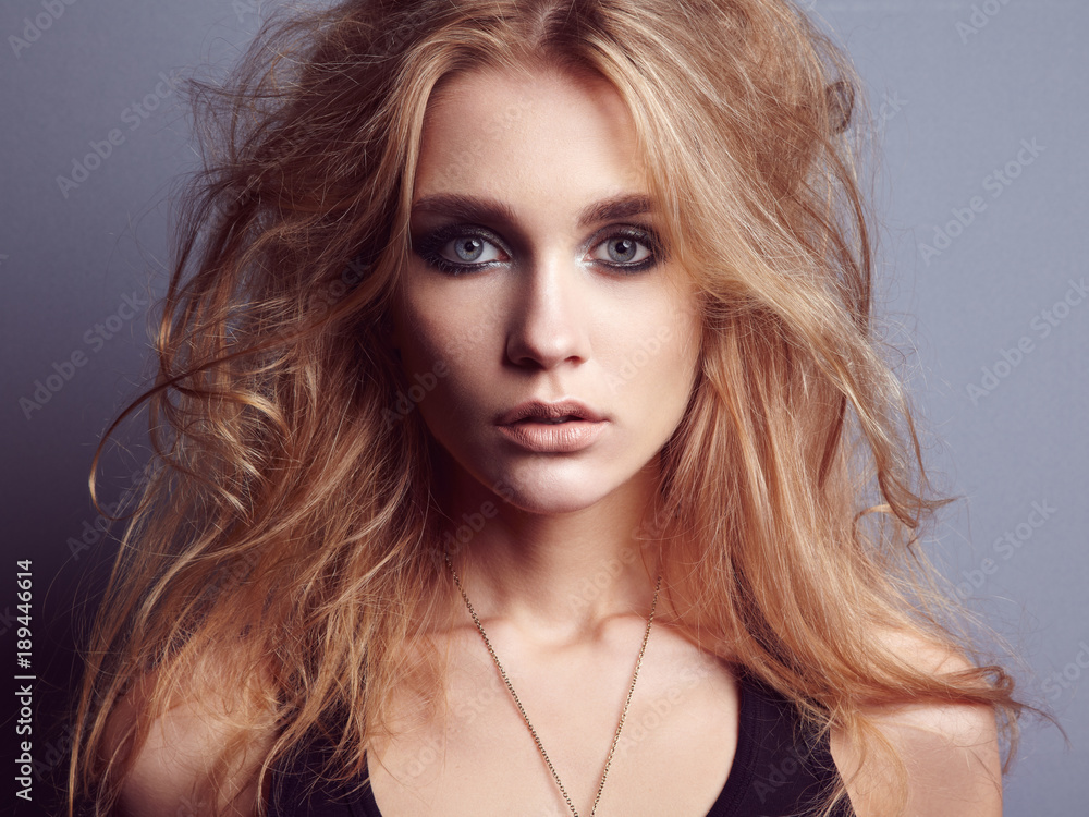 Fototapeta premium Portrait of young beautiful girl with blonde hair. Fashion photo Hairstyle. Make up. Vogue Style