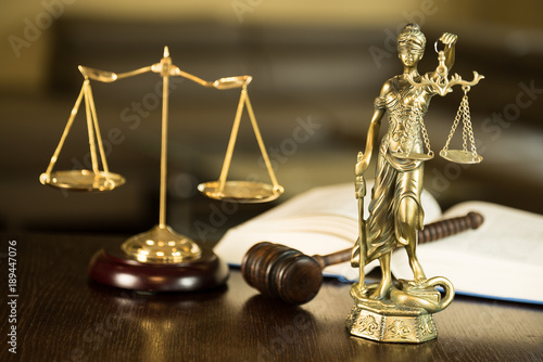 Law and Justice concept. Mallet of the judge, books, scales of justice. Courtroom theme.