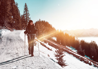 Woman hiking along trail in snowy mountains