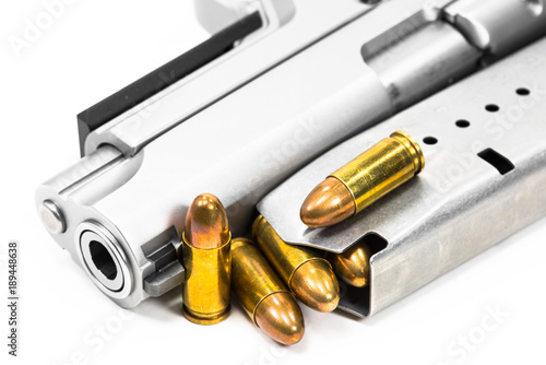 Guns and ammunition are placed on white ground.