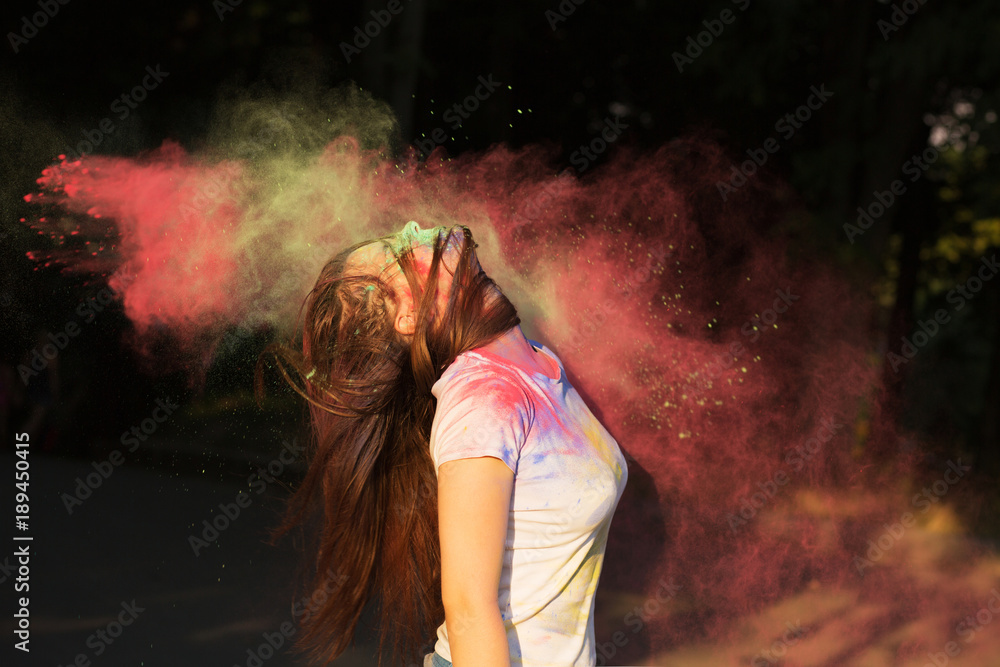 Wonderful young woman with exploding pink powder celebrating Holi festival Wonderful young woman with exploding pink powder celebrating Holi festival