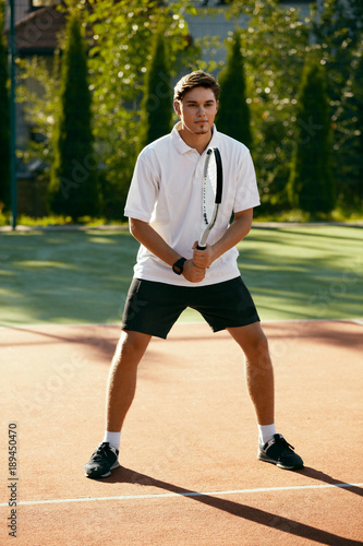 Sports. Male Player Playing Tennis Outdoors. © puhhha