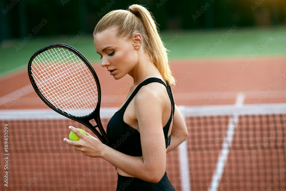 Woman Playing Tennis On Court.