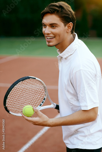 Man Playing Tennis Outdoors. © puhhha