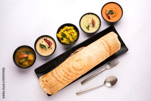 Masala dosa with chutney and sambar and potato sabzi. Cone, triangle or roll shape, selective focus
