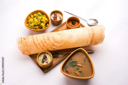 Masala dosa with chutney and sambar and potato sabzi. Cone, triangle or roll shape, selective focus
