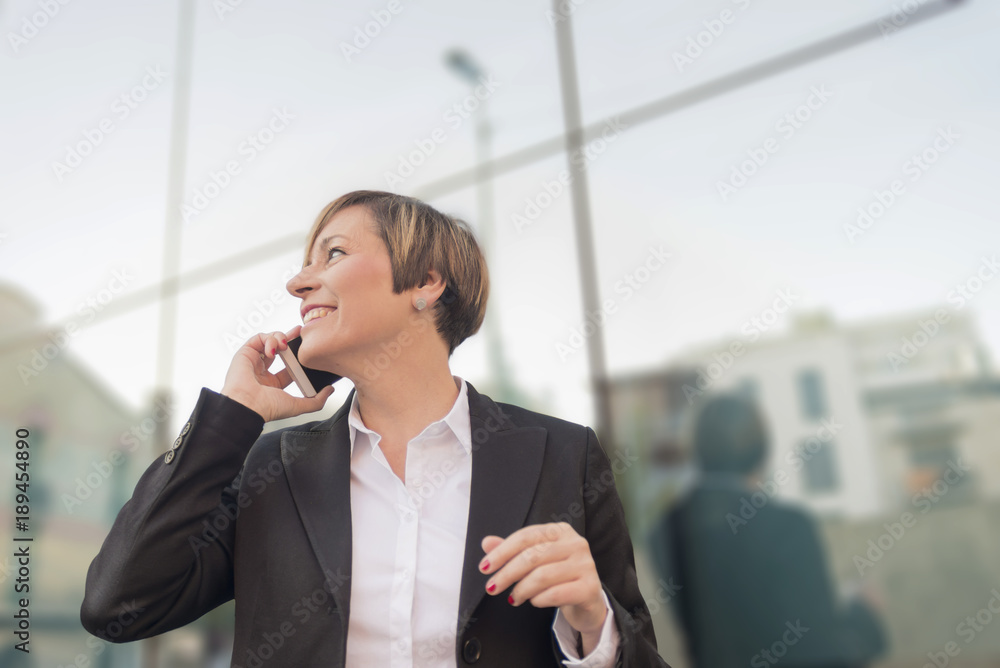 Executive talking on phone looking at camera on the street Executive talking on phone looking at camera on the street