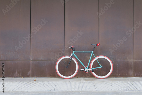 A City bicycle fixed gear on a brown wall photo