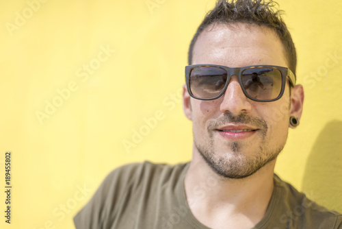 Colorful portrait of a handsome man dressed in green t-shirt