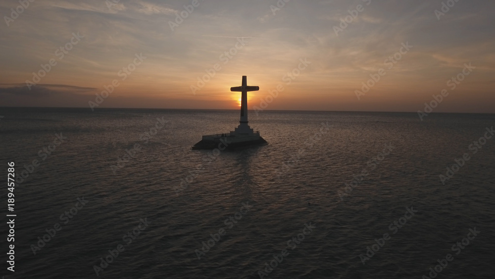 Sunken Cemetery cross in Camiguin Island, Philippines. Large crucafix marking the underwater sunken cemetary of the coast of camiguin island near mindanao in the Philippines. Catholic cross in the