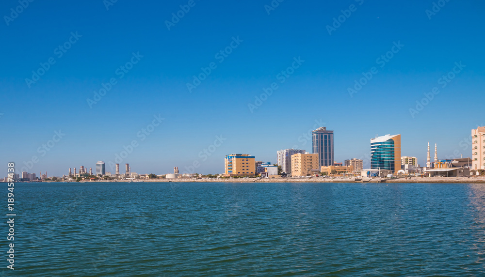 Ras Al Khaimah during sunny day . View to beautiful bay with harbour in background