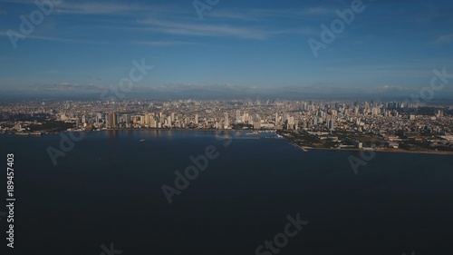 Aerial view skyline of Manila city at sunset. Fly over city with skyscrapers and buildings. Aerial skyline of Manila . Modern city by sea, highway, cars, skyscrapers, shopping malls. Makati district