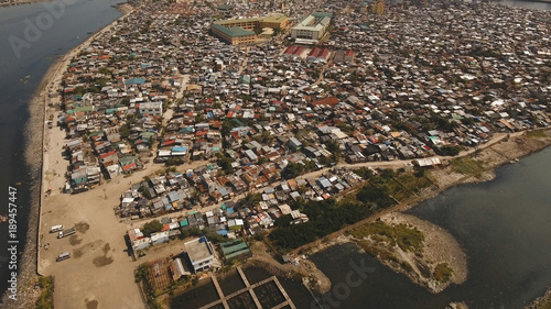 Aerial view poor district of Manila's slums, ghettos, wooden old houses, shacks. Slum area of Manila, Philippines. Manila suburb, view from the plane.