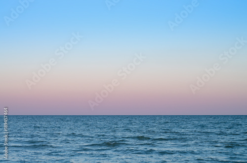 pink sky of sunset on the sea horizon. © balakleypb