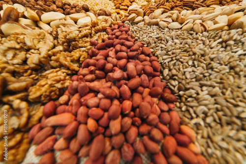 Nuts mix in a canvas bag in table. Ten kinds of nuts: pecan, brazil, cedar, sunflower, hazelnut, almond, peanut, walnut, pistachio, cashew.