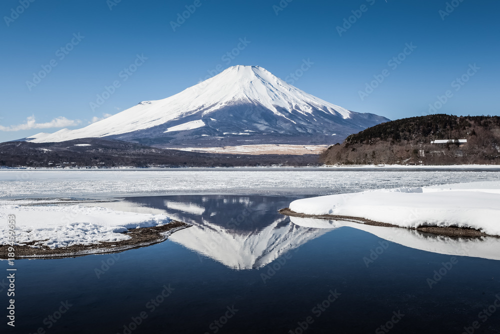 Mountain Fuji with reflection and Yamanakako ice lake in winter Mountain Fuji with reflection and Yamanakako ice lake in winter