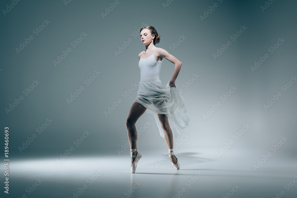 elegant ballerina dancing in white dress