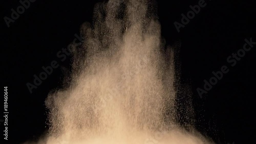 bright yellow powder explosion on black background