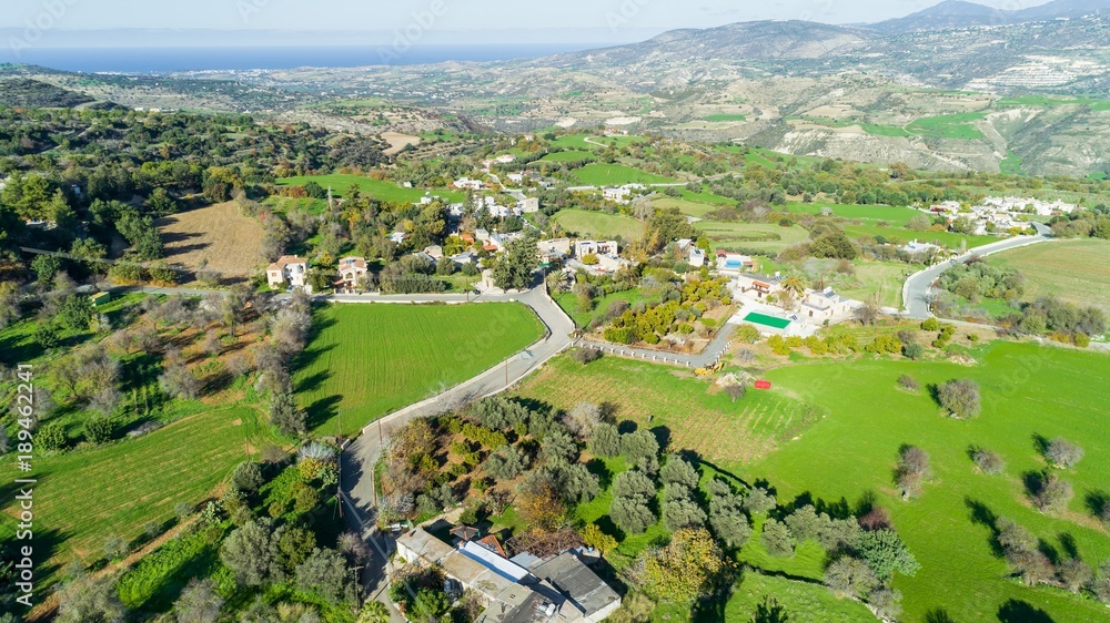 Aerial bird's eye view of traditional village Kato Akourdalia, Paphos, Cyprus. The mountains, valley, trees, nature, Latchi - Akamas beach and agritourism resorts and villas in Pafos from above.