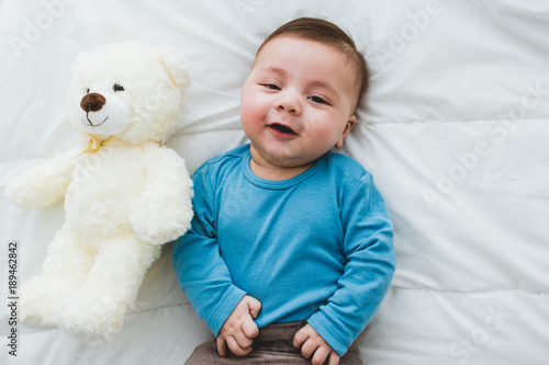 adorable baby with a toy dog by his side