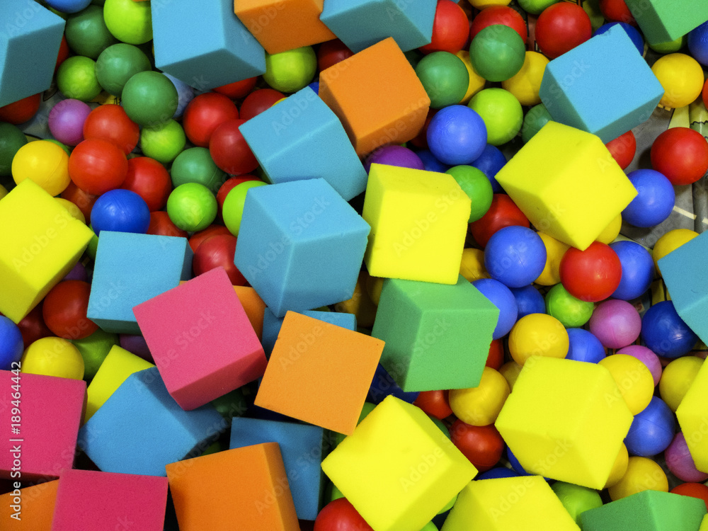 Colored balls and soft cubes in the kiddie pool.