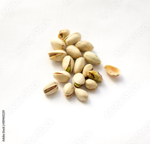 Dry roasted pistachios on the white background
