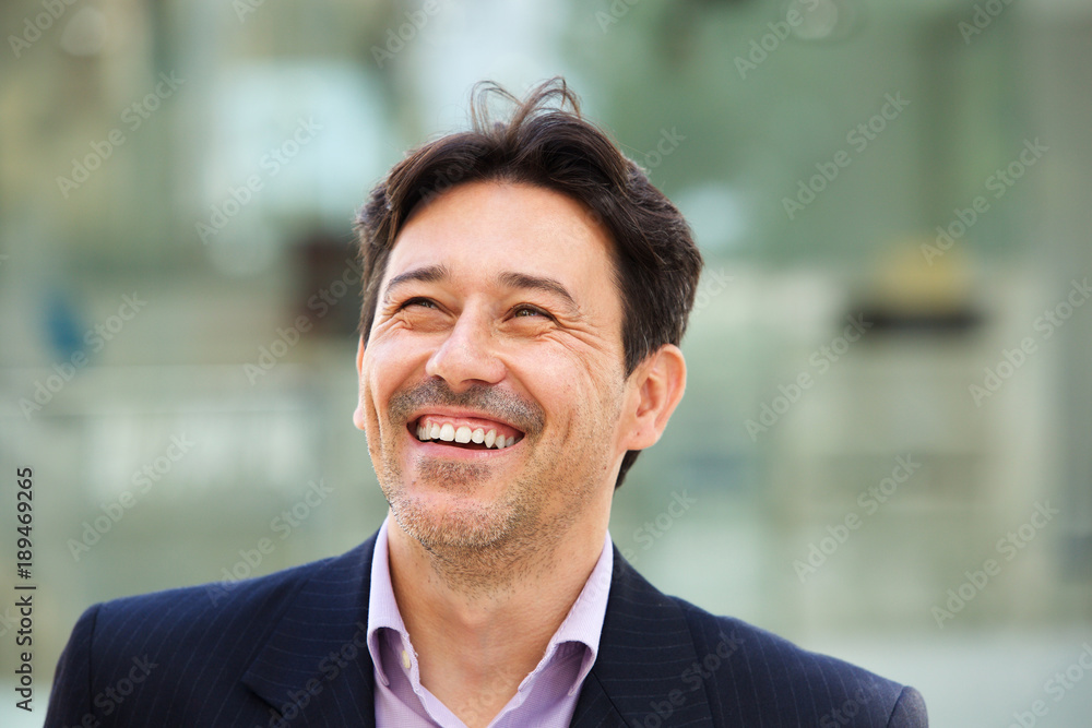 cheerful middle aged man standing outside and smiling cheerful middle aged man standing outside and smiling