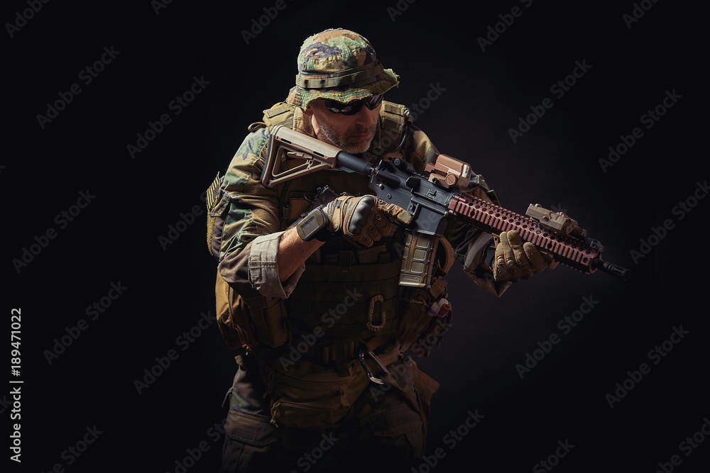 special forces soldier of the united states poses with a rifle on a black background special forces soldier of the united states poses with a rifle on a black background