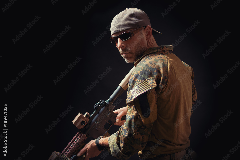 special forces soldier of the united states poses with a rifle on a black background special forces soldier of the united states poses with a rifle on a black background