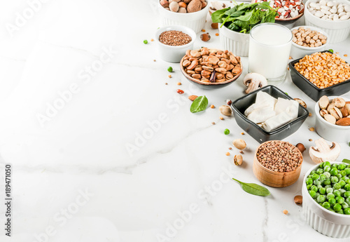 Wallpaper Mural Healthy diet vegan food, veggie protein sources: Tofu, vegan milk, beans, lentils, nuts, soy milk, spinach and seeds. Top view on white table. Torontodigital.ca