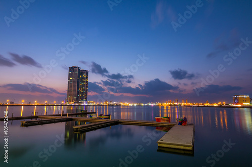 Ras Al Khaimah by night. View to beautiful bay with harbour in background