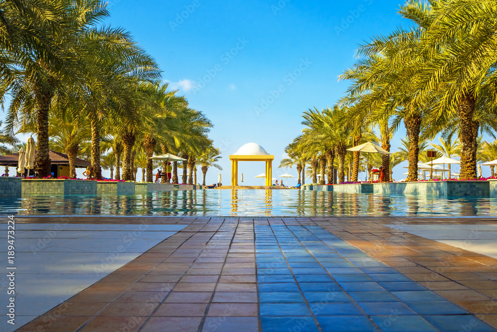 Fototapeta premium The luxury swimming pool with sunbeds