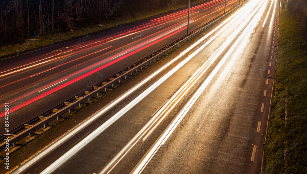 car light streaks motion blur on the highway