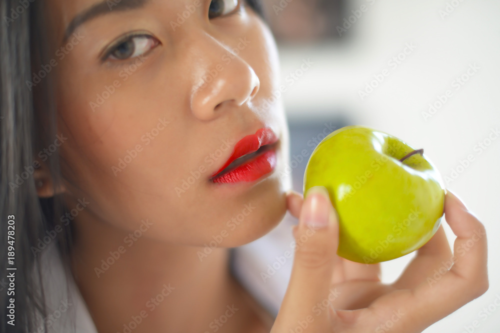 Portrait of happy young woman Asian holding apple
Portrait of happy young woman Asian holding apple