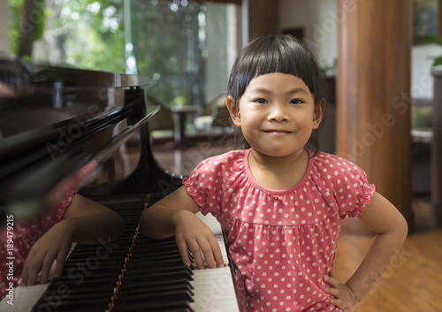 Portrait of Asian little gile with piano photo