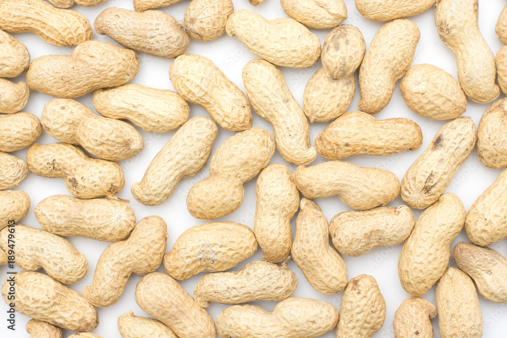 Unshelled peanuts background isolated on white top view. Unshelled peanuts background isolated on white top view.