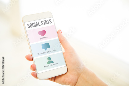 Woman holding a pink gold blank smartphone social stats