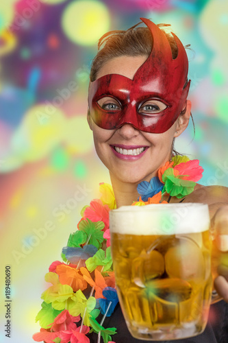 Girl having fun jumping and dancing carnival with mascara necklace of flowers and fan at a party drink beer 