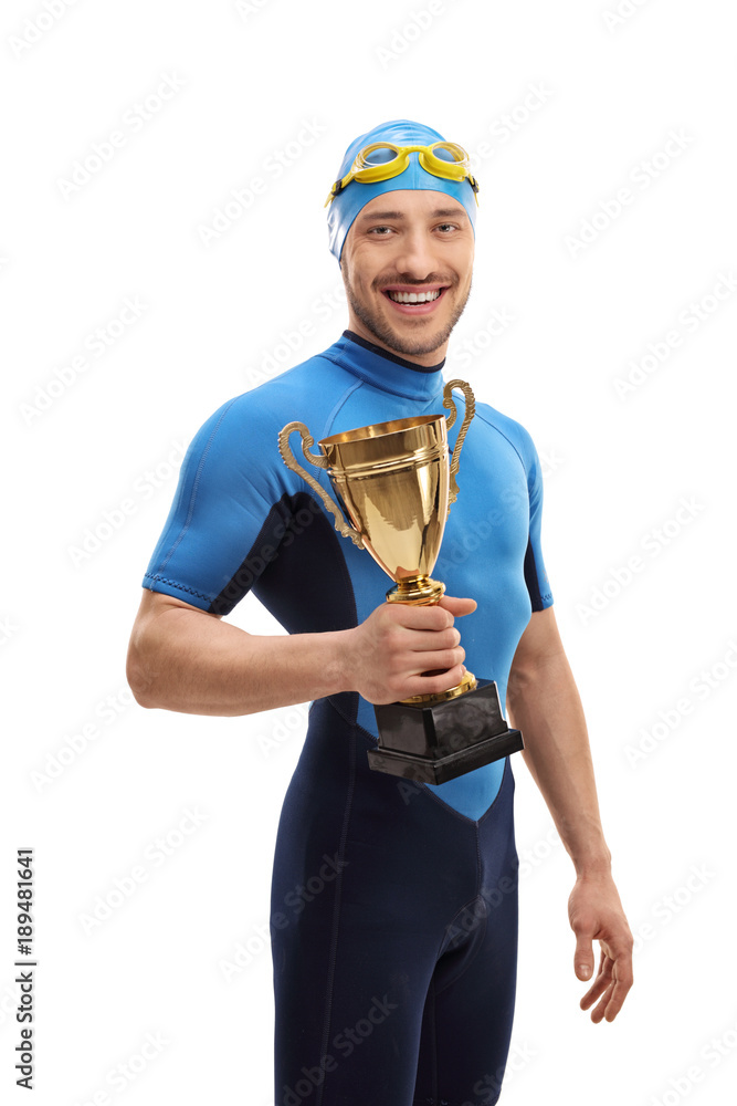 Swimmer holding a golden trophy and smiling Swimmer holding a golden trophy and smiling