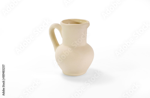 Little unpainted ceramic jug on white background