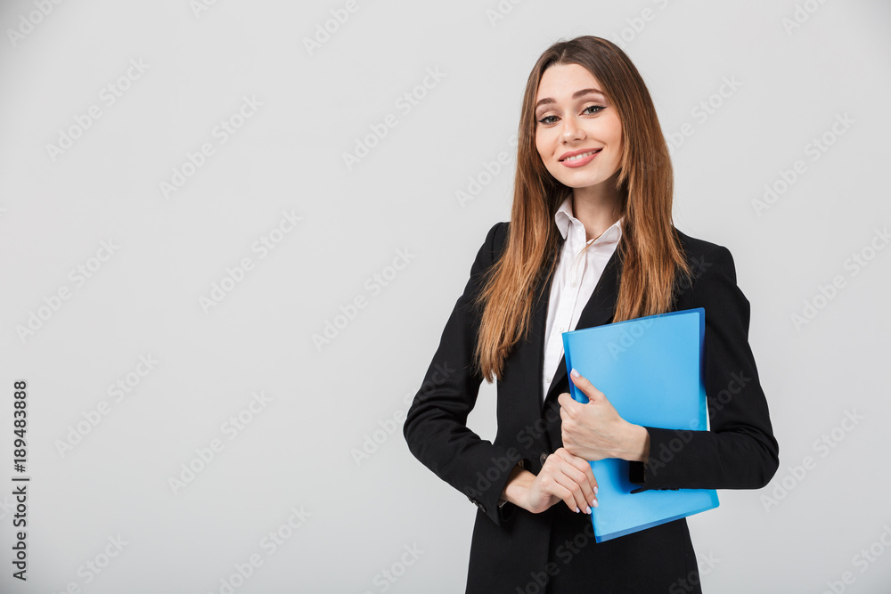 Cheerful businesswoman holding folder and smiling to camera Cheerful businesswoman holding folder and smiling to camera