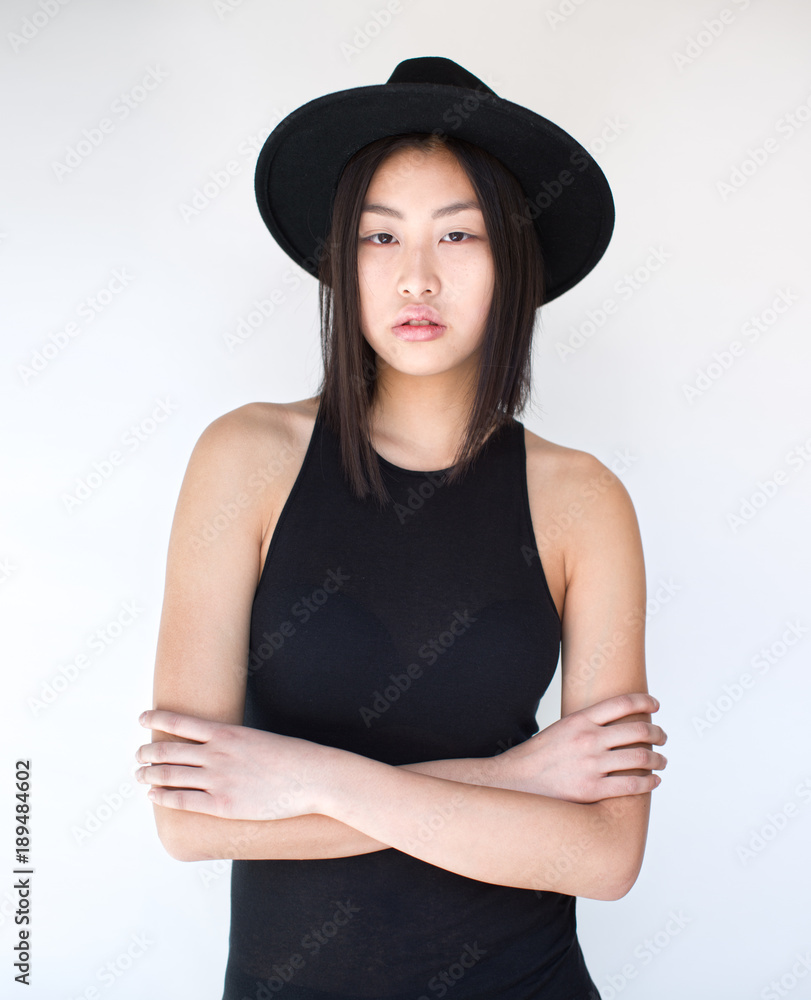 Portrait of young woman standing against white background Portrait of young woman standing against white background