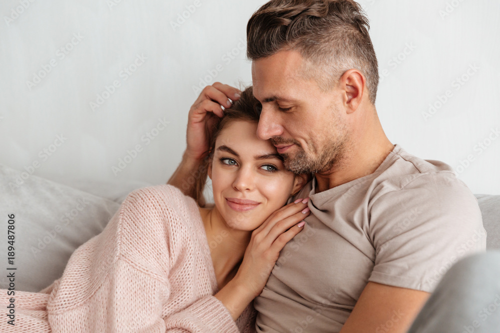 Portrait of a young loving couple resting on a couch Portrait of a young loving couple resting on a couch