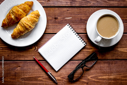 Business breakfast with coffee and croussant top view photo