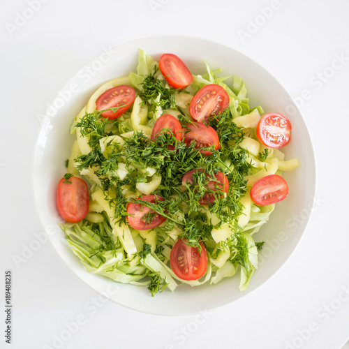 White round plate with vegetable salad. Raw food