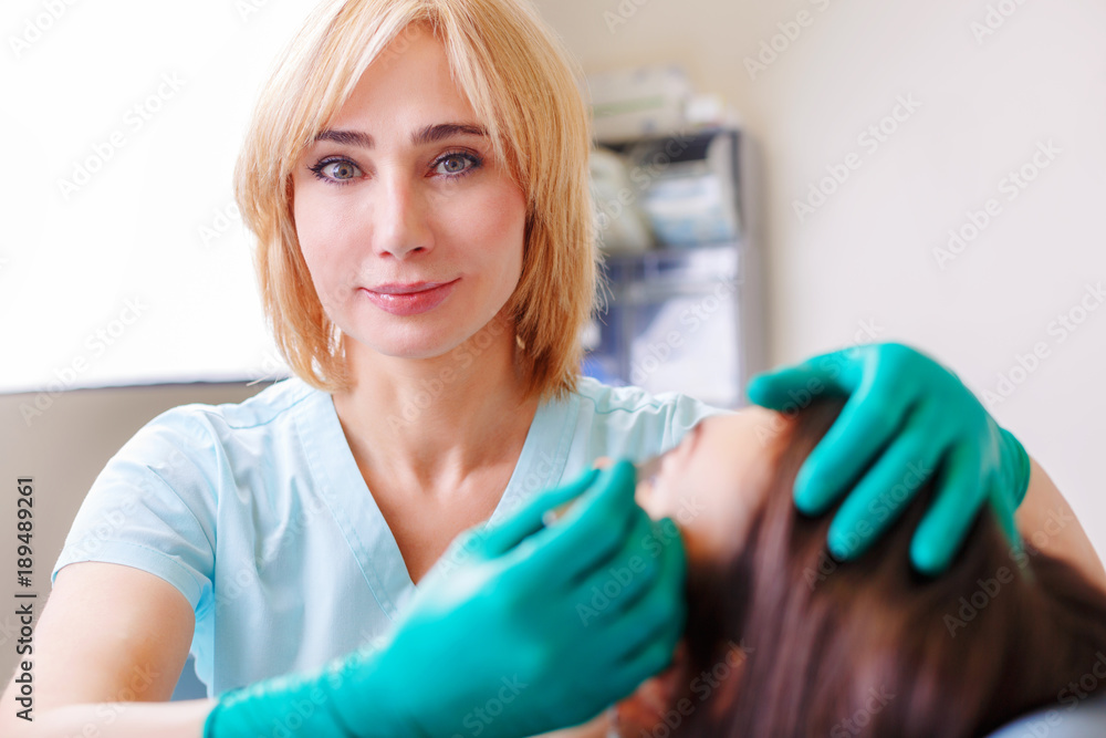Cosmetic surgeon examining female client in clinik before plastic surgery. Blepharoplasty Cosmetic surgeon examining female client in clinik before plastic surgery. Blepharoplasty