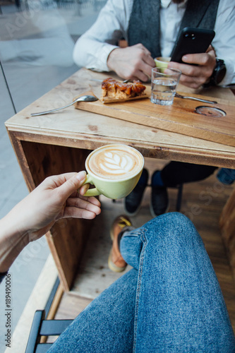 POV shot of woman holding coffee cup during date or meeting with friend or boyfriend, beautiful and inspiring beverage drink image, healthy hipster lifestyle photo